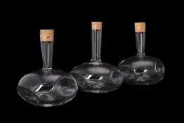 Three limited edition clear glass and dimpled 13° 60° 104° decanters and cork stoppers by Rokos