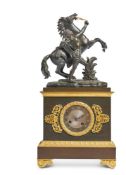 AN EMPIRE STYLE FRENCH BRONZE AND GILT METAL MANTEL CLOCK WITH A MARLY HORSE