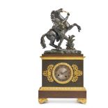 AN EMPIRE STYLE FRENCH BRONZE AND GILT METAL MANTEL CLOCK WITH A MARLY HORSE