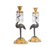 A PAIR OF PATINATED AND GILT BRONZE CANDLESTICKS