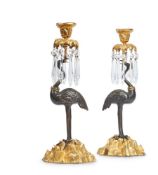 A PAIR OF PATINATED AND GILT BRONZE CANDLESTICKS