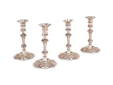 A SET OF FOUR GEORGE IV CAST SHAPED CIRCULAR CANDLESTICKS BY TIMOTHY SMITH & THOMAS MERRYWEATHER