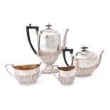 AN EDWARDIAN SILVER OVAL HALF REEDED FOUR PIECE TEA AND COFFEE SERVICE BY WALKER AND HALL