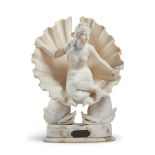 A CARVED ALABASTER GROUP OF VENUS IN A SHELL