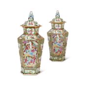 A PAIR OF CHINESE CANTON FAMILLE-ROSE TAPERING HEXAGONAL SECTION VASES AND COVERS