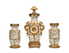 A CHINESE PORCELAIN AND FRENCH GILT METAL MOUNTED CLOCK GARNITURE