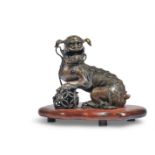 A CHINESE BRONZE FIGURE OF A SEATED DOG OF FO