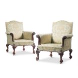 A PAIR OF GEORGE II STYLE CARVED MAHOGANY LIBRARY ARMCHAIRS