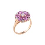 A diamond and pink sapphire flower head cluster ring