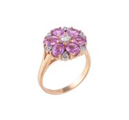 A diamond and pink sapphire flower head cluster ring