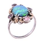 An Arts and Crafts opal doublet and pink tourmaline dress ring in the manner of Bernard Instone