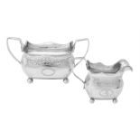 A George III Irish silver oblong baluster sugar bowl and cream jug