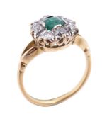 An emerald and diamond cluster ring