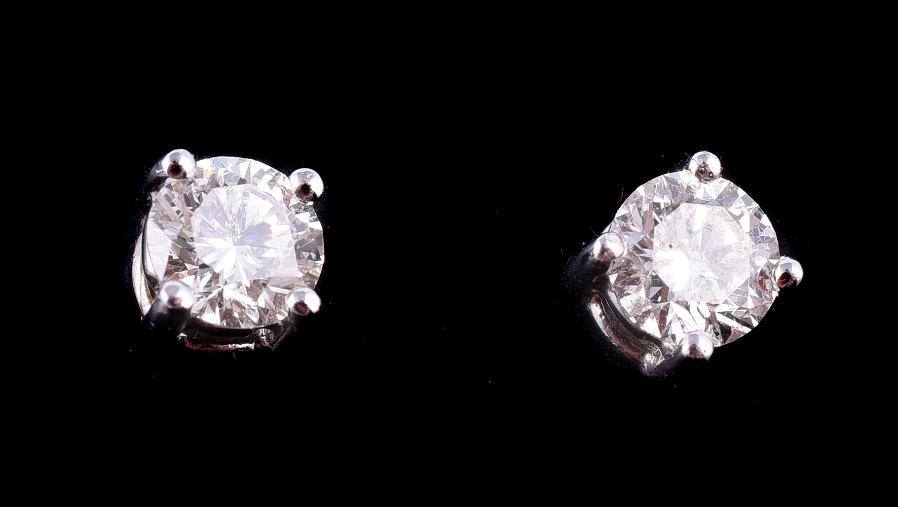 A pair of diamond stud earrings