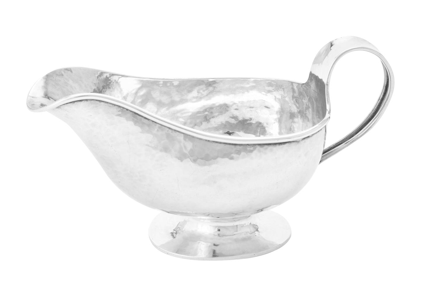 A silver oval sauce boat by A. E. Jones