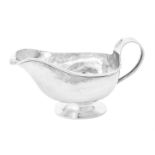 A silver oval sauce boat by A. E. Jones