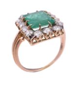 An emerald and diamond cluster ring