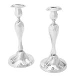 A pair of German silver coloured candlesticks