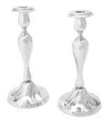 A pair of German silver coloured candlesticks
