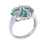 A diamond and emerald dress ring