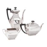 A late Victorian silver three piece half gadrooned tea and coffee set by Atkin Brothers