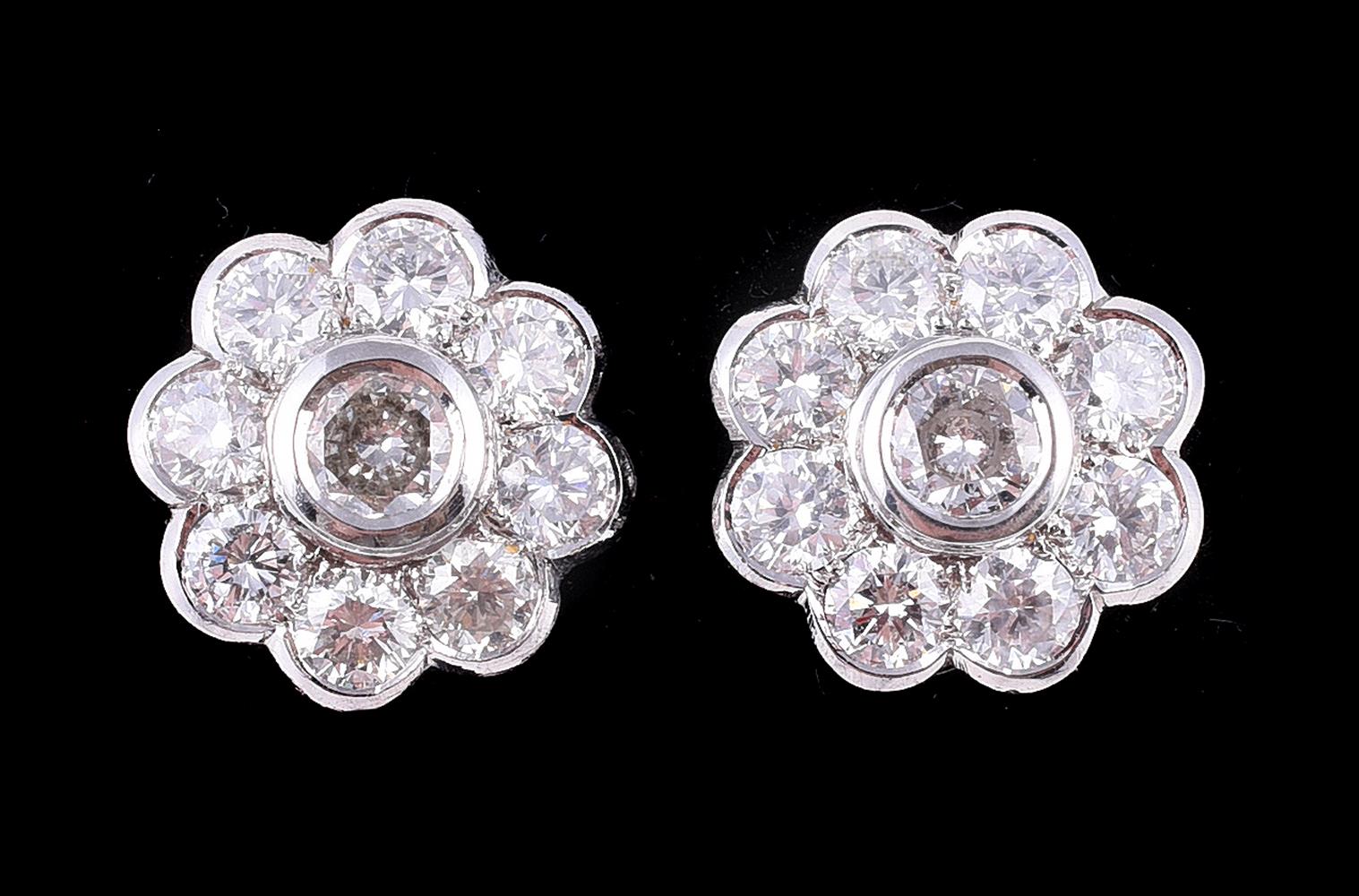 A pair of diamond flower head cluster earrings