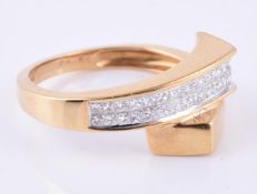 An 18 carat gold diamond crossover dress ring