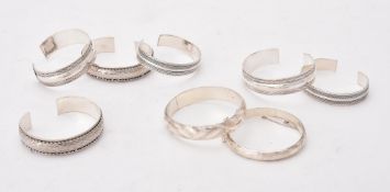 A collection of silver and silver coloured bangles