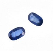 † Pair of unmounted oval mixed cut sapphires