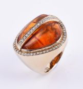 A diamond and pressed amber dress ring