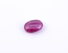 † An oval cabochon unmounted ruby