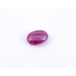 † An oval cabochon unmounted ruby