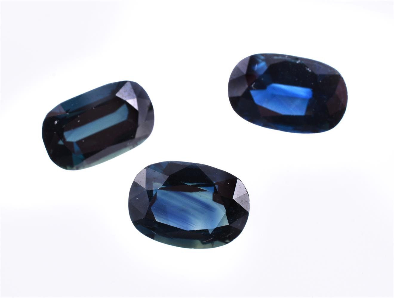 † Three unmounted oval cut sapphires