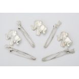 A quantity of silver elephant and flower brooches