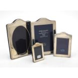 Four silver mounted shaped rectangular photo frames