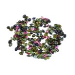 † A packet of unmounted oval cut pink and green tourmalines