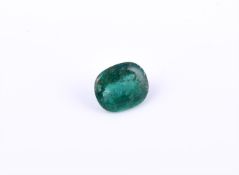 † An unmounted oval cabochon emerald