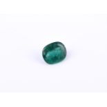 † An unmounted oval cabochon emerald