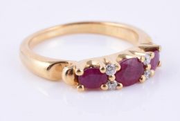 A synthetic ruby and diamond seven stone ring
