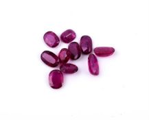 † A packet of unmounted oval cut rubies