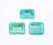 † Three unmounted step cut emeralds