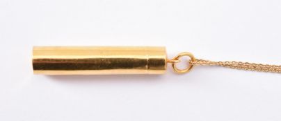 A gold coloured tubular pendant