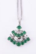 An emerald and diamond pendant