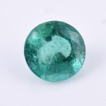 † An unmounted circular cut emerald