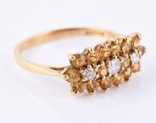 A diamond and yellow sapphire triple cluster ring