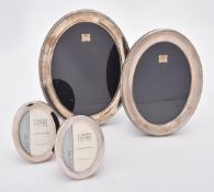 Four silver mounted oval photo frames