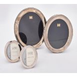 Four silver mounted oval photo frames
