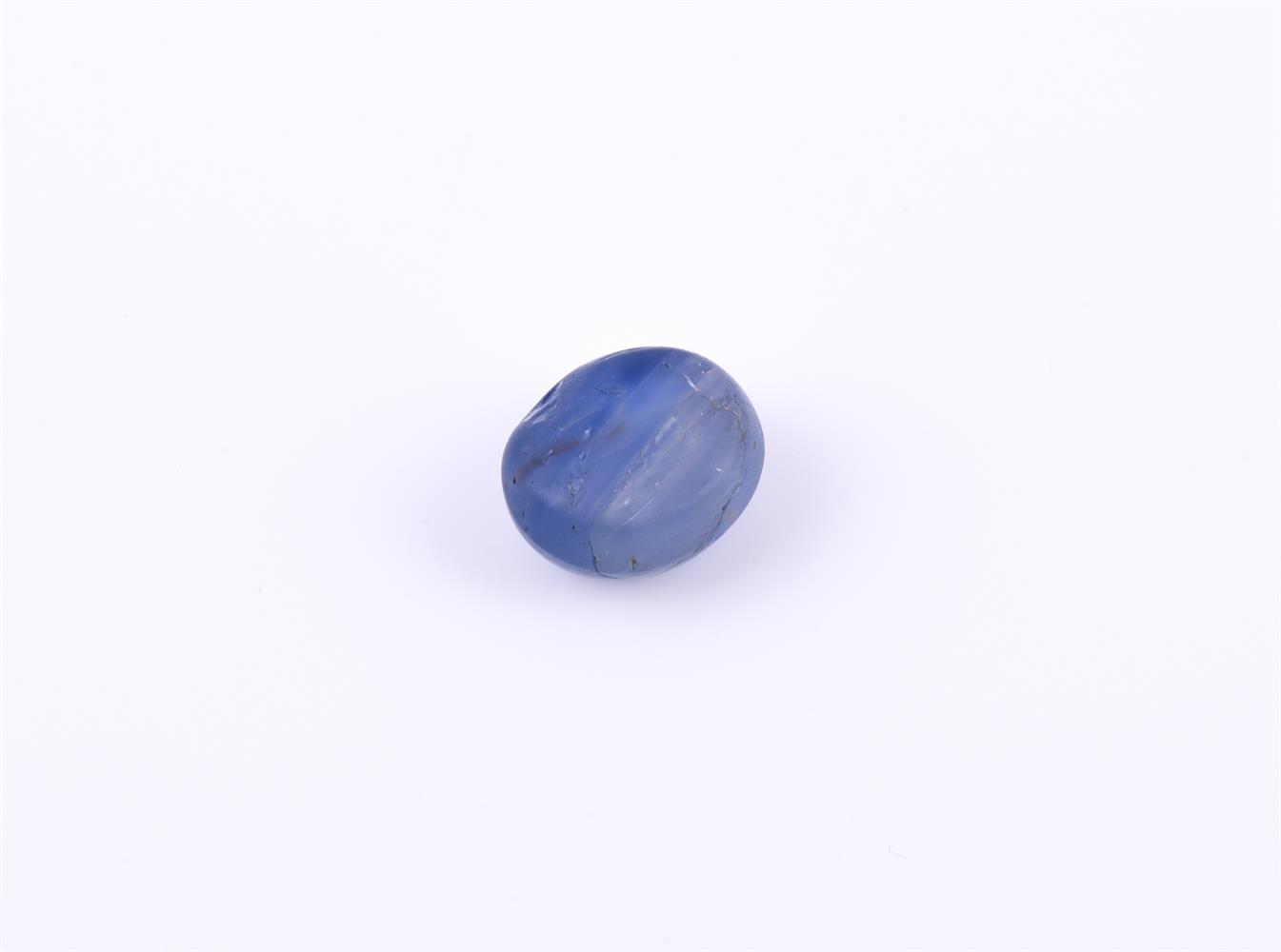 † An oval cabochon star sapphire