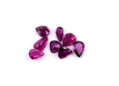 † A parcel of unmounted pear cut rubies