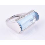 A diamond and blue topaz dress ring